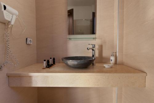 a bathroom with a sink with a bowl sink at Kamares Villas in Kamáres