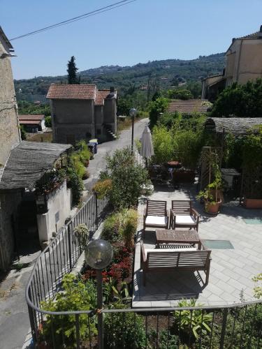 an outdoor patio with benches and flowers on a balcony at Monolocale con giardino e parcheggio privato CITRA zero zero ottanta trentuno LT 0281 in Imperia