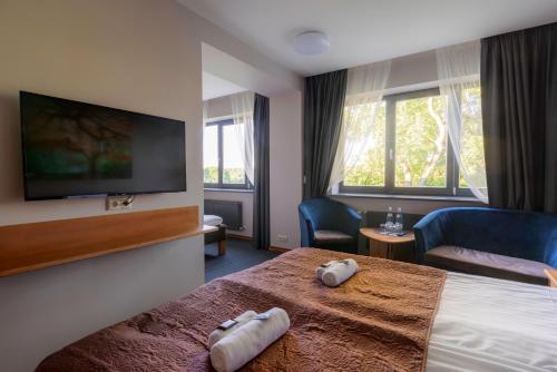 Tempat tidur dalam kamar di Comfort Hotel Kuldiga