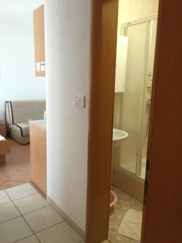 a bathroom with a toilet and a tub in a room at Apartments MAMPAS in Neum