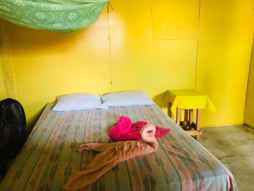 a bedroom with a bed with a stuffed animal on it at Cool Spot Grace Place in Little Corn Island