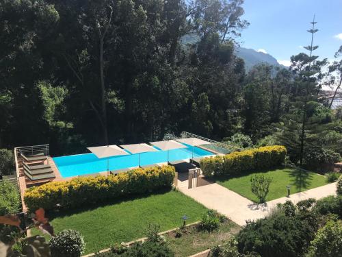 une maison avec une piscine dans un jardin dans l'établissement Les résidences du port appartements meublés, à Porto Ota