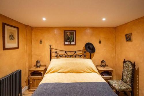 a bedroom with a large bed and a chair at Fagin's Den in Broadstairs - Winter special offers! in Broadstairs