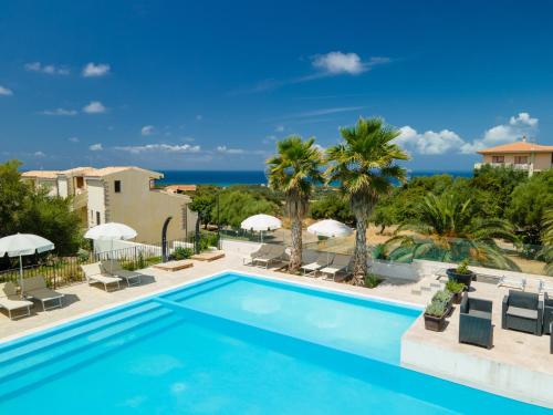 a swimming pool with a view of the ocean at Horizon Hotel Badesi in Badesi