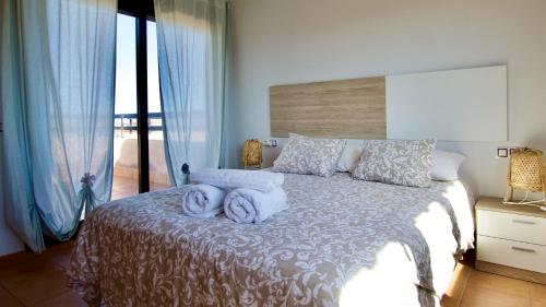 a bedroom with a bed with towels on it at The Wind's Breath, perfect for relaxing getaway in La Oliva