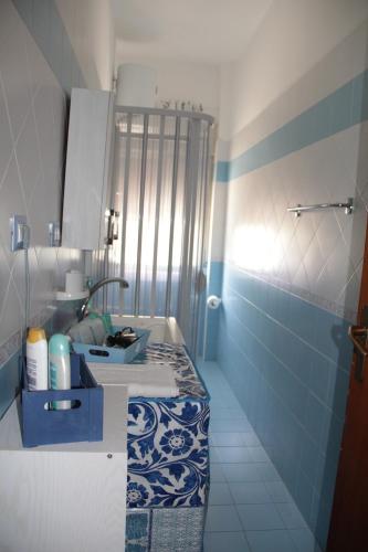 a blue and white bathroom with a sink and a mirror at Holiday Beach in Milazzo