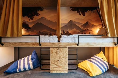 a bunk bed with a view of a mountain mural at Superbude Wien Prater in Vienna