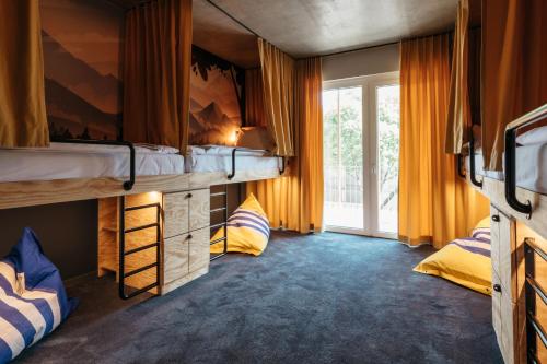 a bedroom with two bunk beds and a window at Superbude Wien Prater in Vienna