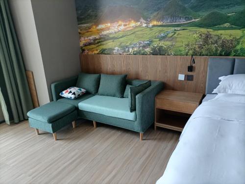 a hotel room with a couch and a bed at TRUE Go hotel in Chengdu