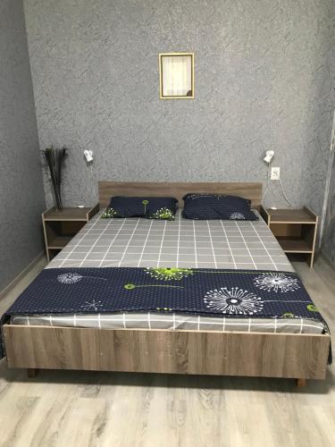 a bedroom with a bed with blue and white sheets at Apartments O.Polya ( Kirova) 106 in Dnipro