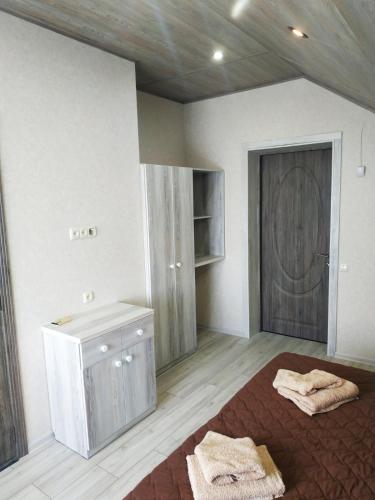 a bathroom with two towels on the floor and a door at Sanpic in Sanzhiyka