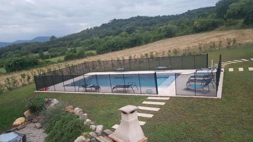 a swimming pool in the middle of a field at Allotjatments Can Servosa in Sales del Llierca