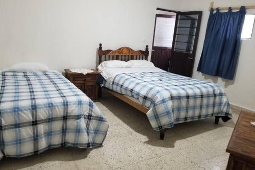 a bedroom with two beds and a mirror at Casa completa en pleno centro de Ciudad Valles in Ciudad Valles