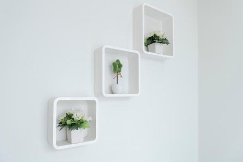 a group of four white boxes with plants in them at Mee Hug Guesthouse in Phayao