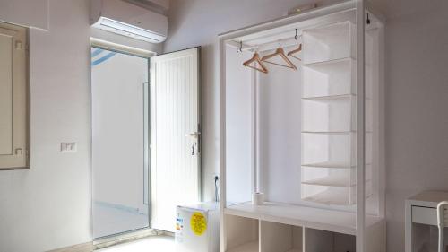 a white refrigerator in a room with a window at Pepi B&B in Santa Maria di Castellabate