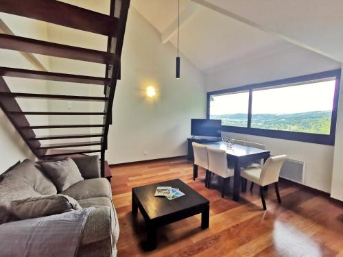 a living room with a couch and a table at Terres de France - Domaine du Palais in Saint-Lizier