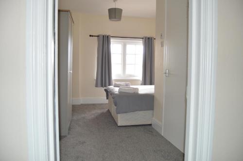 a bedroom with a bed and a window at The Rose & Crown in Bulford