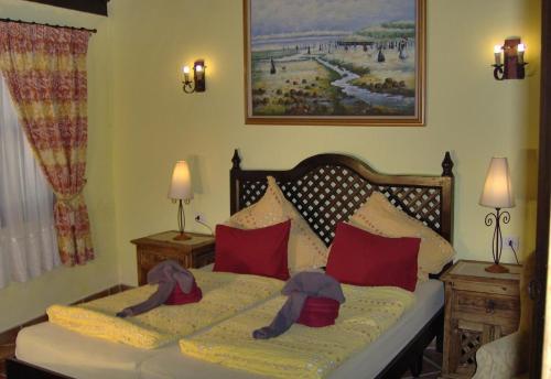 a bedroom with a bed with red pillows at Aptos Monasterio de San Antonio 1 in Icod de los Vinos