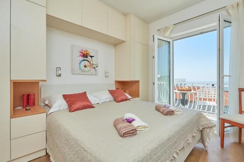 a bedroom with a large bed with two pillows on it at Villa Kate Dadić in Dubrovnik