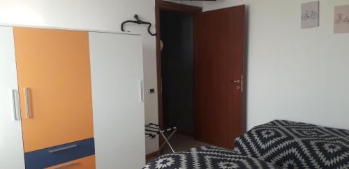 a bedroom with a bed and a closet with a mirror at BIKE HOUSE "evo" in Seriate