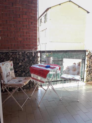 a table and two chairs on a patio at BIKE HOUSE "evo" in Seriate