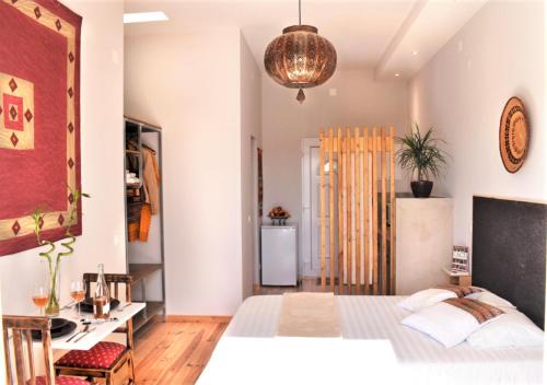 a bedroom with a bed and a desk in it at Heaven's Edge in São Brás de Alportel