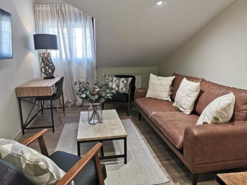 a living room with a couch and a table at Hotel Arco Navia in Navia