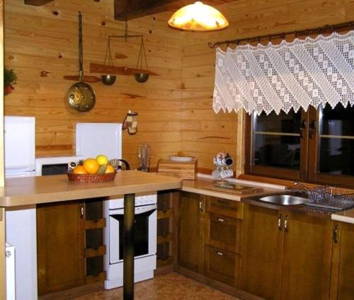 a kitchen with a counter with a bowl of fruit on it at Dom nad jeziorem - Mazury in Rańsk