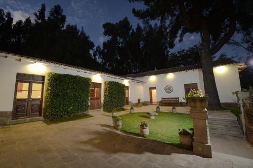 a courtyard of a house at night with lights at Palacio Manco Capac by Ananay Hotels in Cusco