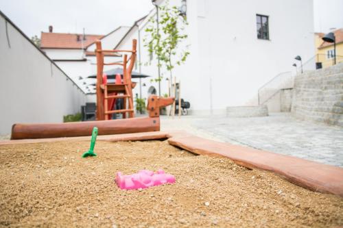 a sandbox with a toy in the sand at Hotel Restaurant Na Návsi in Říčany u Brna