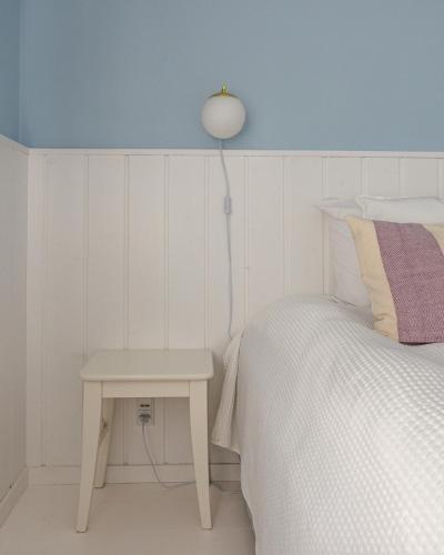 a bedroom with a bed and a table with a lamp at Egn Boutique Hotel in Stege
