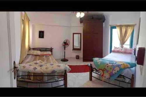 a bedroom with two beds and a window at Cozy Relaxed Ground Chalet with Terrace-Ras Sudr in Ras Sedr