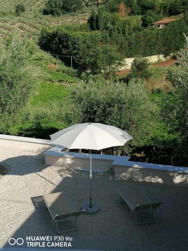 an umbrella and two chairs on a patio at Cantina Loft in Chieti