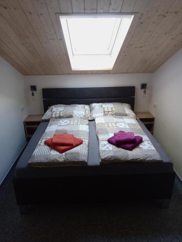 a bedroom with a bed with two pillows on it at U Hradeb in Mikulov