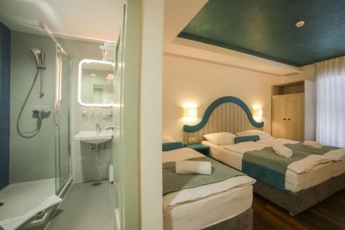 Ένα ή περισσότερα κρεβάτια σε δωμάτιο στο Hotel Ivando