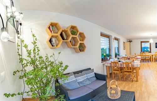 a living room with a couch and a table at Domek Plaster Miodu in Istebna