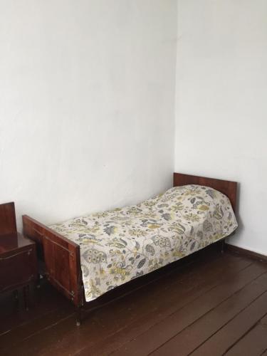 a small bed in a corner of a room at Hotel Rafinad in Sharhorod