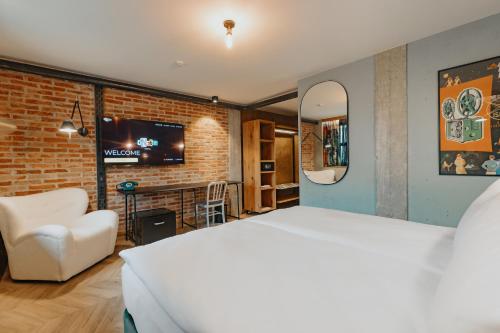 Postel nebo postele na pokoji v ubytování ONE66 Hotel