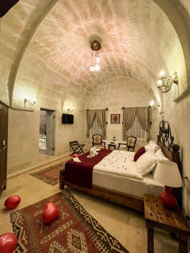 a bedroom with a large bed in a large room at Kemerli House in Avanos