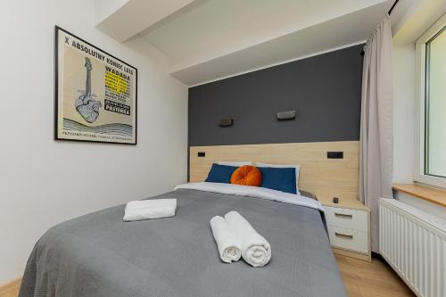 a bedroom with a bed with two towels on it at Hostel Szczelinka in Pasterka