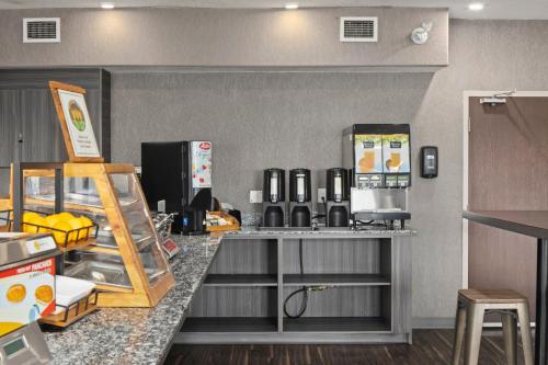 a kitchen with a counter with a coffee maker at Home Inn & Suites Saskatoon South in Saskatoon