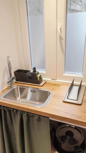 a kitchen counter with a sink and a window at Fiorino Rooms Korčula in Korčula