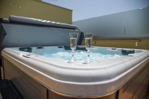 two glasses of champagne in a hot tub at Holiday Home Tos in Risika
