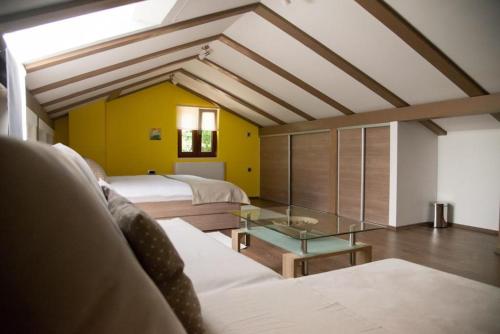 a room with two beds and a glass table at Holiday Home Tos in Risika