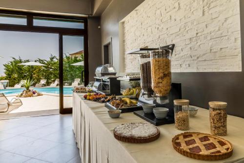 a buffet with food on a table in a kitchen at Affittacamere Villa Bisceglia in Monte SantʼAngelo