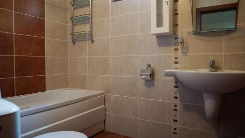 a bathroom with a sink and a toilet and a sink at Апартамент Сънрайз Обзор - Apartment Sunrise Obzor in Obzor