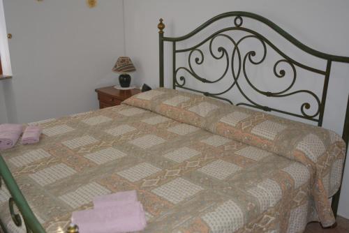 a bed with a quilt on it in a bedroom at Villa Mischianti in Gubbio