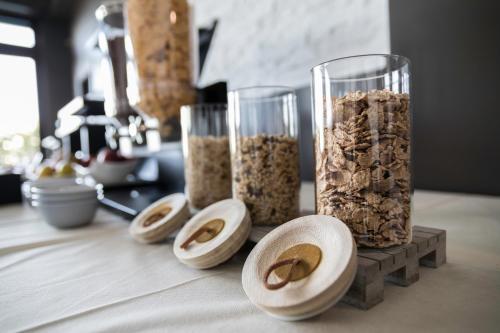a table with a vase filled with oatmeal and three bowls at Affittacamere Villa Bisceglia in Monte SantʼAngelo