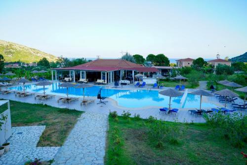 an overhead view of a swimming pool with tables and umbrellas at Pacifae Hotel in Katelios