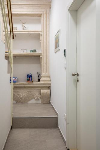 a hallway with white walls and a white door at GAMA Dubrovnik 1 in Dubrovnik